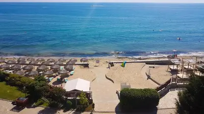 an aerial view of a beach with umbrellas and the ocean at Apartment Garden of Eden in Sveti Vlas