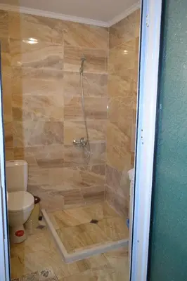 a bathroom with a shower with a toilet at Apartment Aquamarine in Burgas City