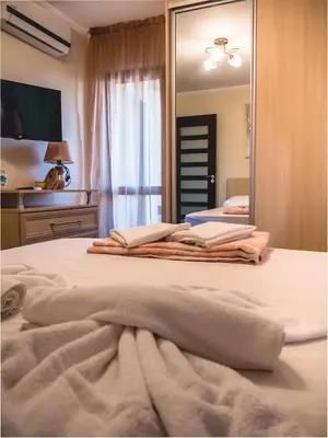 a mirror on a bed with towels on it at Apartment 7 and Studio 2 Quietly and peaceful place to relax in Sozopol