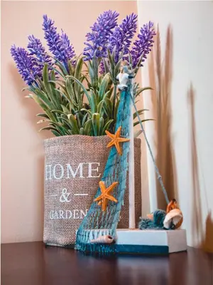 a vase with purple flowers on a table at Apartment 7 and Studio 2 Quietly and peaceful place to relax in Sozopol