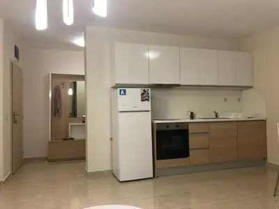a kitchen with white cabinets and a white refrigerator at Star Dreams, Sveti Vlas in Sveti Vlas
