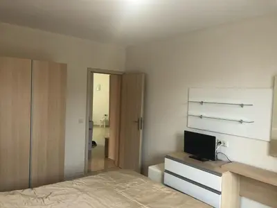 a bedroom with a bed and a television on a dresser at Star Dreams, Sveti Vlas in Sveti Vlas