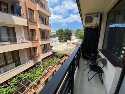 an apartment balcony with two chairs and plants on it at Mario Beach Apartment Nessebar in Nesebar