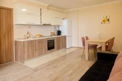 a kitchen and dining room with a table in a room at Apartment EliMar in Burgas City