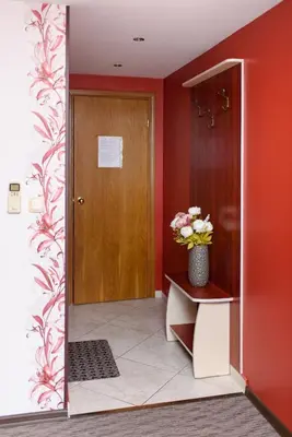 a hallway with a door and a vase of flowers at Guest House Ianis Paradise in Nesebar