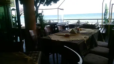 a table in a restaurant with a view of the ocean at Hotel Blian in Ravda