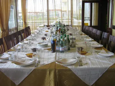 a long table with plates and glasses on it at Hotel Blian in Ravda