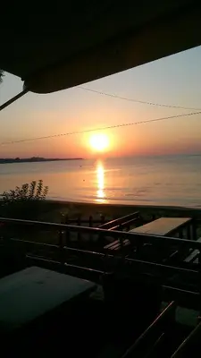 a sunset over the ocean with the sun setting at Hotel Blian in Ravda