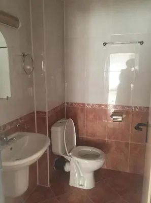 a bathroom with a toilet and a sink at Central Plaza Apartment in Sunny Beach