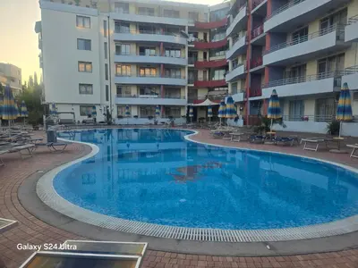 a large swimming pool in front of a building at Central Plaza Apartment in Sunny Beach