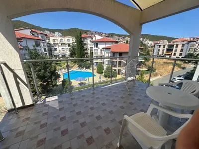 a balcony with a view of a pool and buildings at Triumph Holiday Village in Sveti Vlas