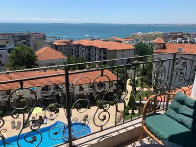 a balcony with a view of a pool and buildings at Triumph Holiday Village in Sveti Vlas