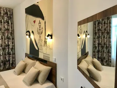 a bedroom with two beds with pillows at Apartment RAYA in Obzor
