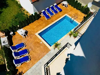 an overhead view of a swimming pool with lounge chairs at Apartment RAYA in Obzor