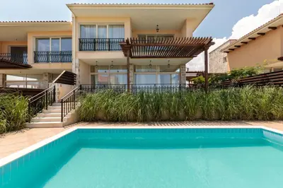 a house with a swimming pool in front of a house at Coral Luxury Villas in Lozenets