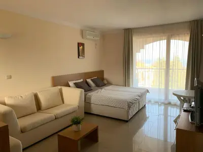 a living room with a bed and a couch at Bay Apartments Sozopol in Sozopol