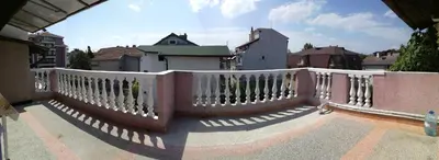 a balcony with a white railing on a building at Anele,Kiten in Kiten