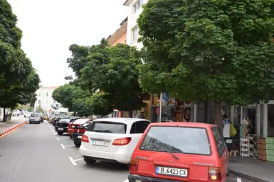 a row of cars parked on the side of a street at Нестандартно Бутиково студио за двама Романтика in Varna City