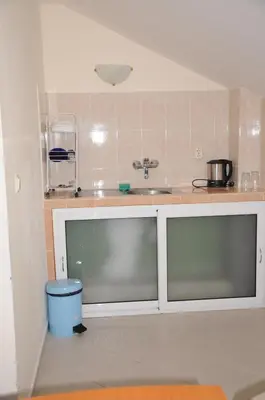 a kitchen with a sink and a counter top at Hotel Babeva in Sveti Vlas