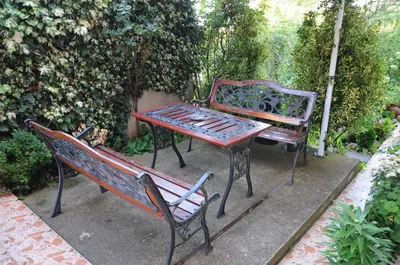 two benches sitting next to a table and a table at Hotel Babeva in Sveti Vlas