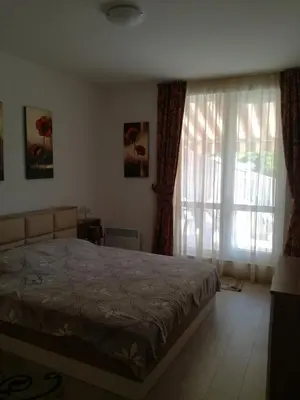 a bedroom with a bed and a large window at Apartament Nora01 in Burgas City