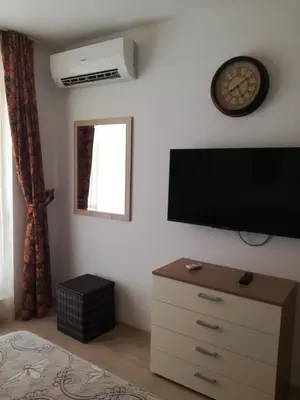 a bedroom with a flat screen tv on the wall at Apartament Nora01 in Burgas City