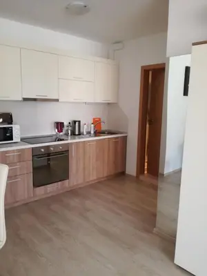 a kitchen with white cabinets and a stove top oven at Apartament Nora01 in Burgas City