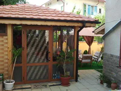 a wooden pavilion with a roof on a patio at Vila Riviera in Chernomorets