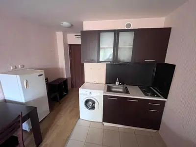 a small kitchen with a washing machine and a sink at Julia Vigo Panorama apartments in Nesebar