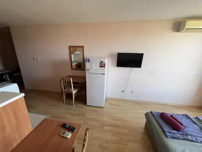 a kitchen with a white refrigerator and a table at Julia Vigo Panorama apartments in Nesebar