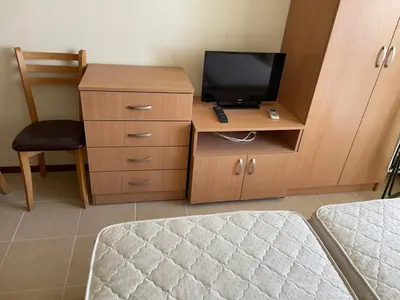 a room with a desk with a television and a chair at Julia Vigo Panorama apartments in Nesebar