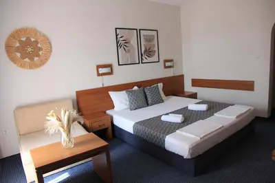 a hotel room with a bed and a table at Hotel Liani - All Inclusive in Sunny Beach