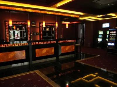 a room with a bar with slot machines at Iva Resort in Byala