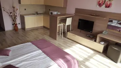 a living room with a bed and a television at Iva Resort in Byala