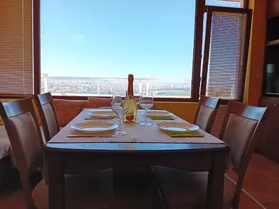 a table with a bottle of wine and glasses at Apartament Zaliva in Varna City