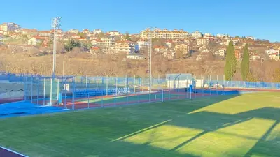 a tennis court with a city in the background at PANORAMA SUNRISE Byala Studio - rest and seaside recreation in Byala