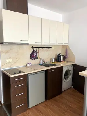 a kitchen with white cabinets and a washing machine at PANORAMA SUNRISE Byala Studio - rest and seaside recreation in Byala
