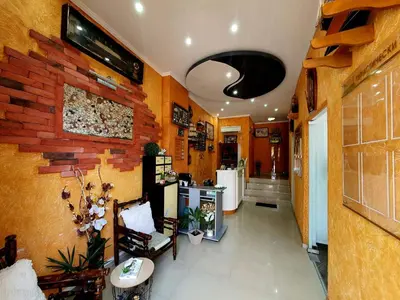a room with a lobby with a brick wall at Family Hotel Paros in Pomorie
