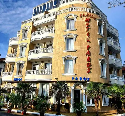 a large yellow building with a raza sign on it at Family Hotel Paros in Pomorie