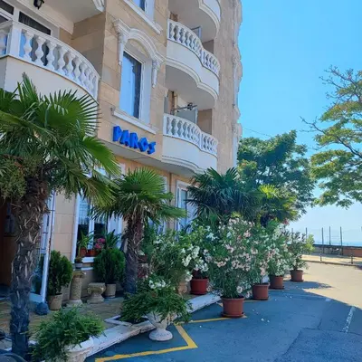 a building with a bunch of plants in front of it at Family Hotel Paros in Pomorie