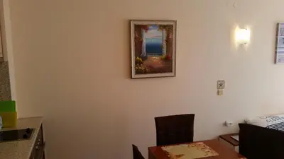 a room with a table and a picture on the wall at Aqua Dreams - new wifi in Sveti Vlas
