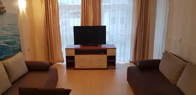 a living room with a couch and a tv on a dresser at Aqua Dreams - new wifi in Sveti Vlas