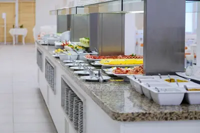 a buffet line with many plates of food at Hotel Garden Nevis - All Inclusive in Sunny Beach