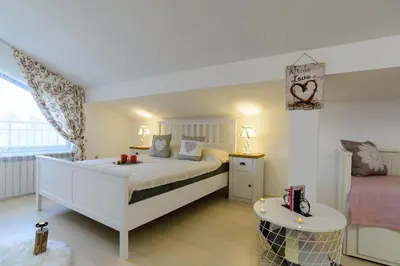 a bedroom with a large bed and a table at Villa Varna View in Varna City