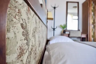 a row of beds with white pillows in a bedroom at Family Hotel Apolonia in Sozopol
