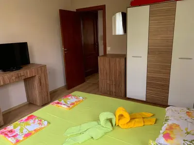 a bedroom with a bed with towels on it at Jacky's Apartament - Апартамент в Свети Влас in Sveti Vlas