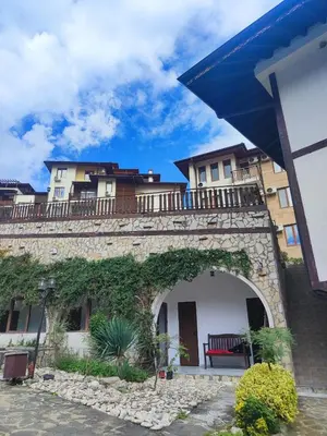 a stone wall with a bench on top of it at Jacky's Apartament - Апартамент в Свети Влас in Sveti Vlas