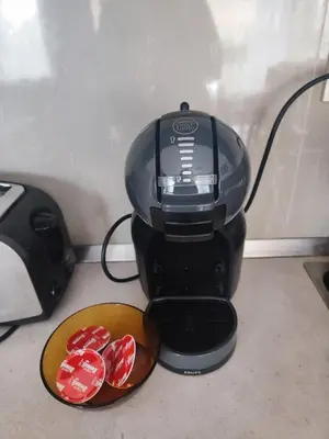 a black coffee maker with a bowl of red chocolates at Jacky's Apartament - Апартамент в Свети Влас in Sveti Vlas