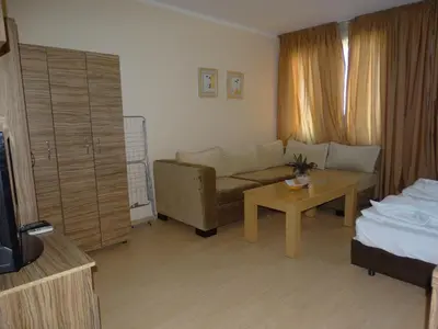 a living room with a couch and a table at Chateau del Marina Apart Complex in Nesebar