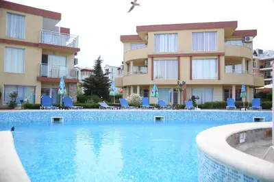 a swimming pool in front of a building at Mappy Holidays Aparthotel in Sozopol